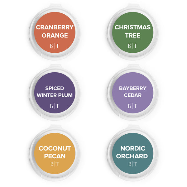 Cranberry Orange, Christmas Tree, Spiced Winter Plum, Bayberry Cedar, Coconut Pecan, and Nordic Orchard Scent Samples on white background.