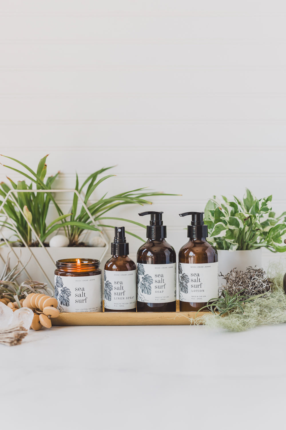 Sea Salt Surf Bundle including 9oz Sea Salt Surf Soy Candle, 4oz Sea Salt Surf Linen Spray, 8oz Sea Salt Surf Body Lotion, and 8oz Sea Salt Surf Liquid Soap.