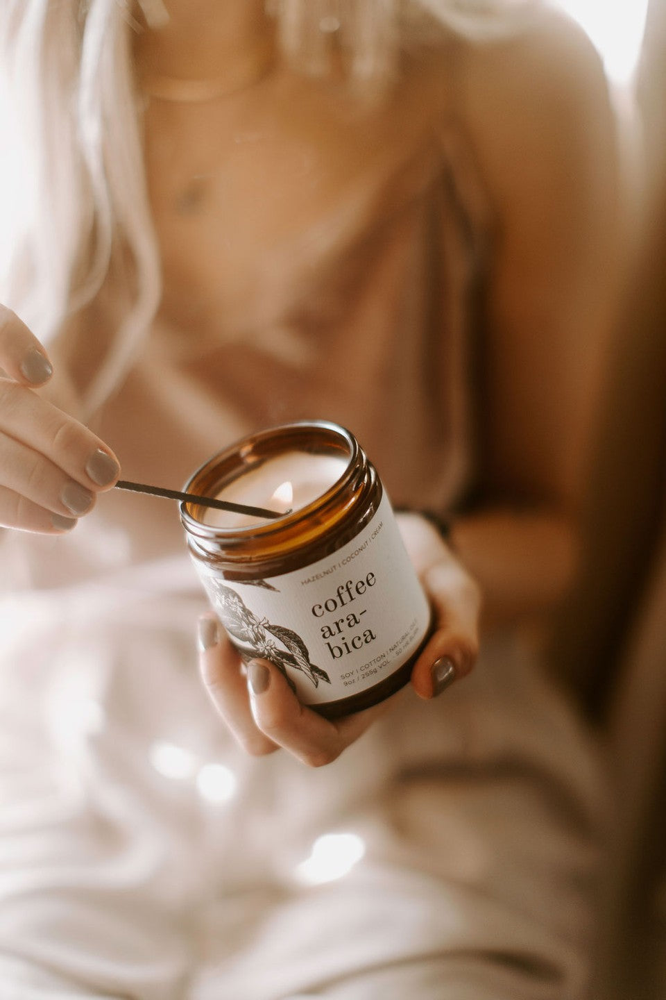 9oz Coffee Arabica Soy Candle being lit by a match. 