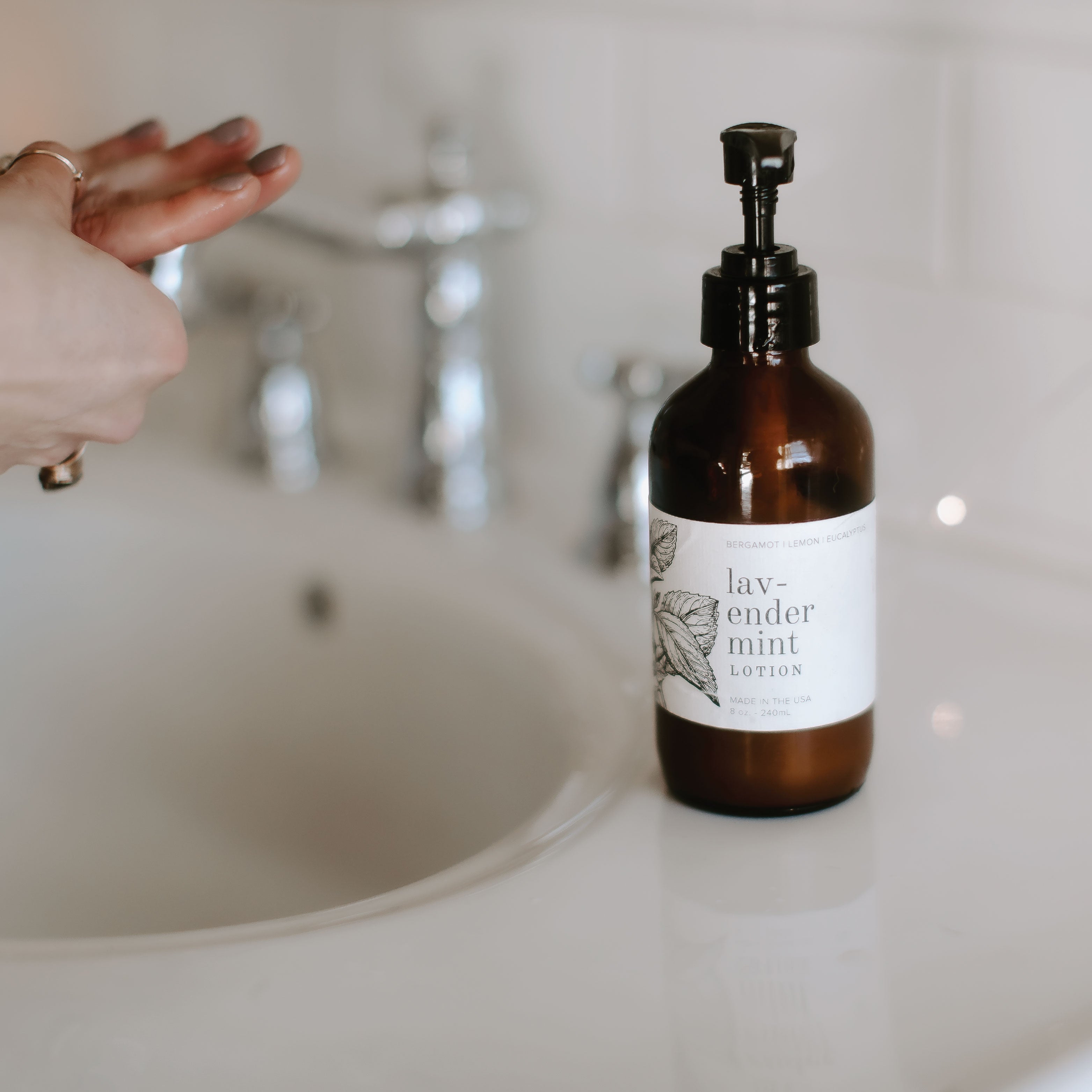 8oz Lavender Mint Body Lotion next to a bathroom sink.