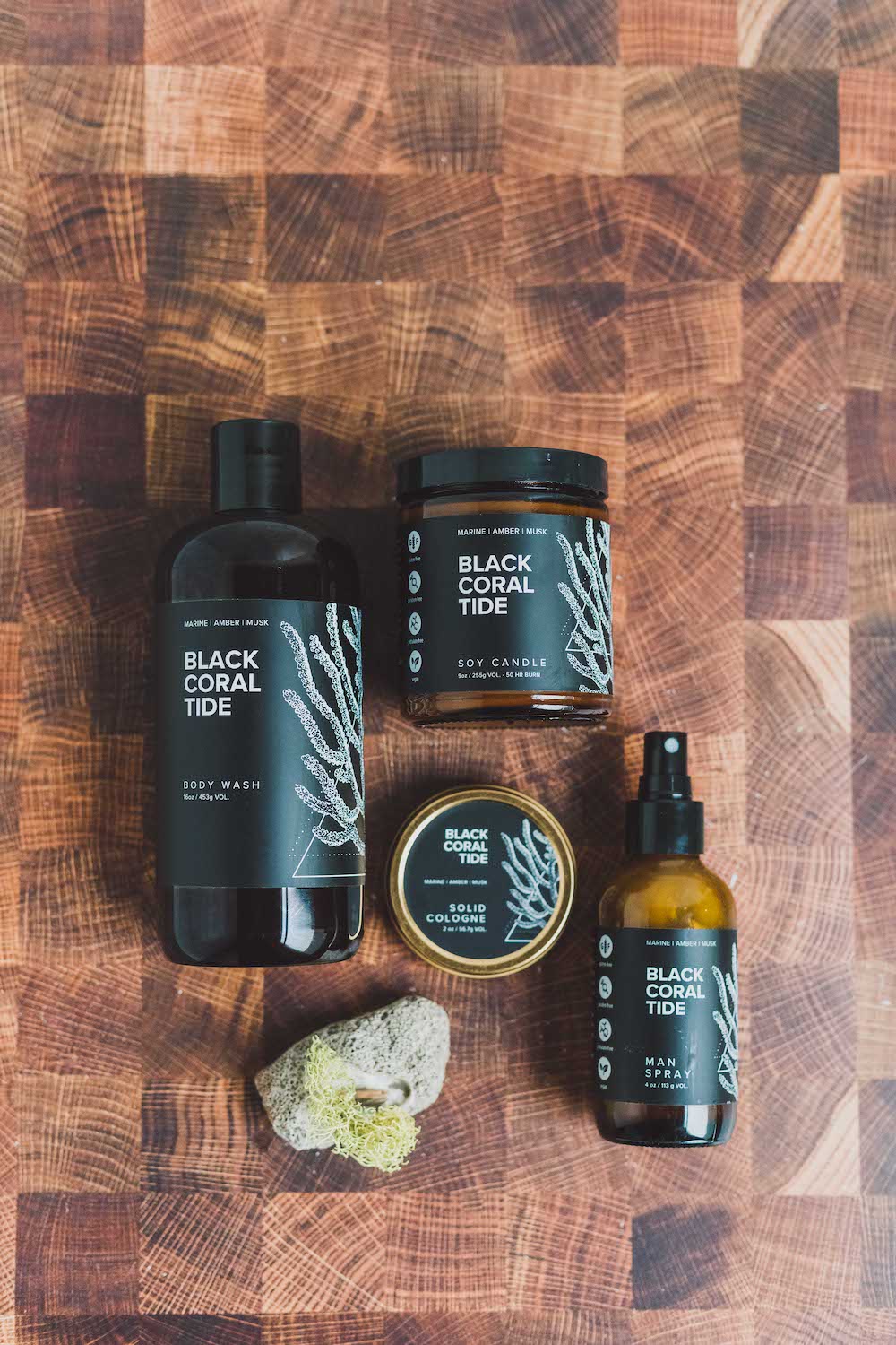 Black Coral Tide product collection including Soy Candle, Solid Cologne, Linen Spray, and Body Wash. 