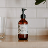 8oz Cardamom Vanilla Liquid Soap on a wooden shelf. 