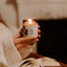 9oz Sea Salt Surf Soy Candle being held by two hands. 