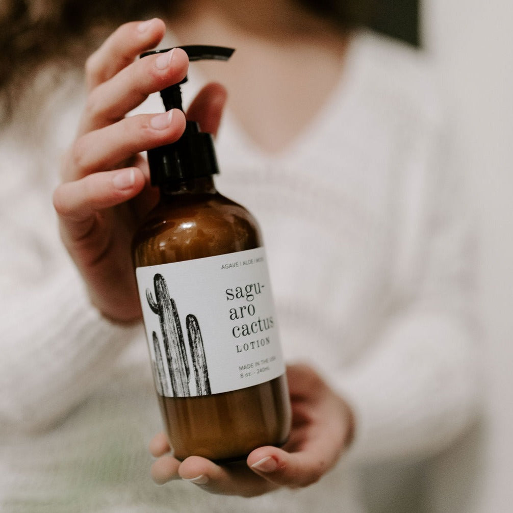 8oz Saguaro Cactus Body Lotion being held by two hands. 