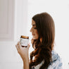 9oz Mount Bachelor Soy Candle being smelled by a woman. 
