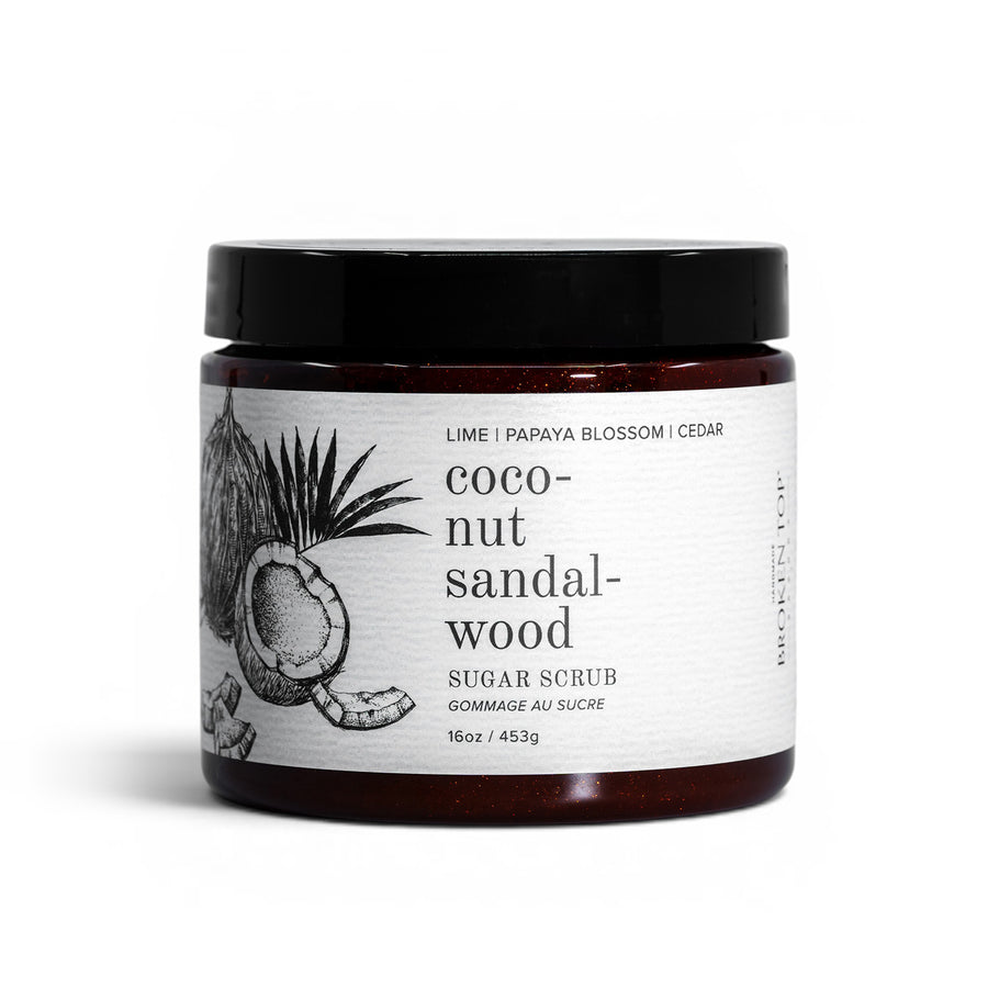 A jar of Coconut Sandalwood Sugar Scrub on a white background.