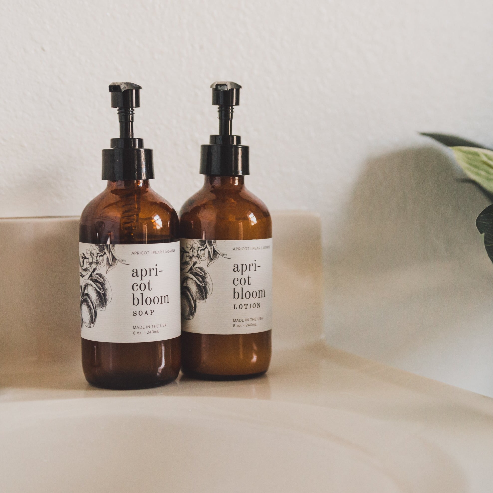 Apricot Bloom 8oz Liquid Soap and 8oz Apricot Bloom Body Lotion on a countertop.