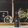 1oz Sitka Woodland Beard Oil on bathroom counter with grooming products in the background. 