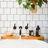 16oz Birch Charcoal Body Wash on bathtub with 9oz Birch Charcoal Soy Candle. 