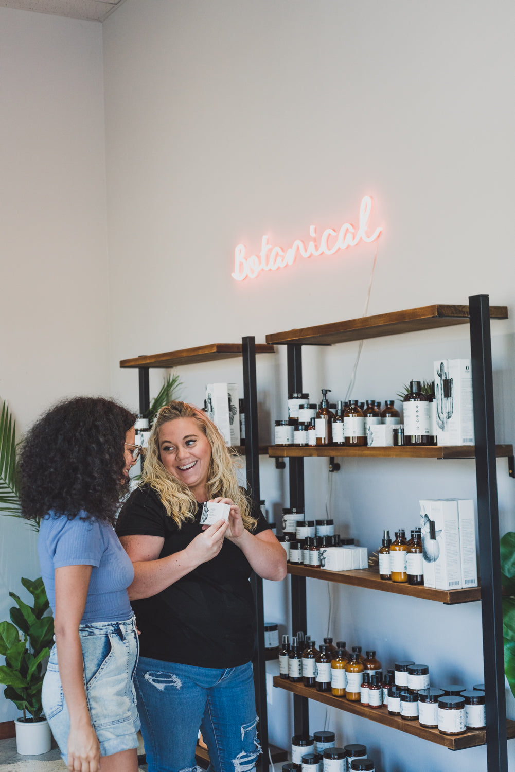 Two women shopping for Broken Top Brands products in a retail store. 