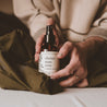 4oz Christmas Tree Linen Spray being held by two hands. 