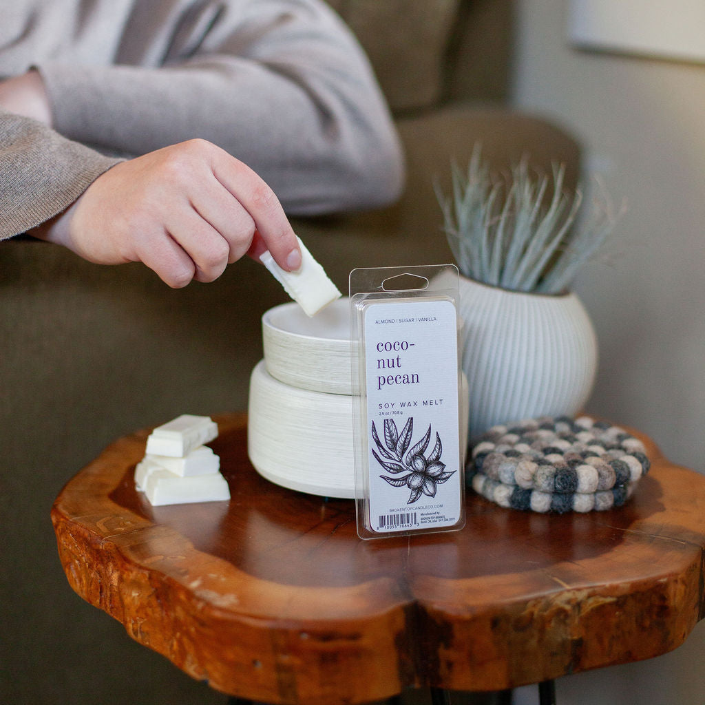 Coconut Pecan Wax Melts being placed into a white wax melter. 
