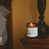 9oz Cranberry Orange Soy Candle on wooden side table. 