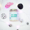 'I've Been Naughty' 9oz Soy Candle on a marble countertop next to mini disco balls and cowboy hats. 