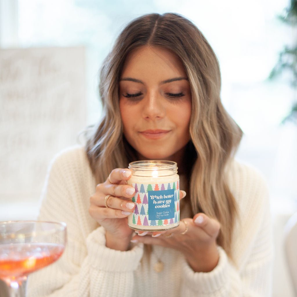 'B*tch Better Have My Cookies' 9oz Soy Candle being held by a woman. 