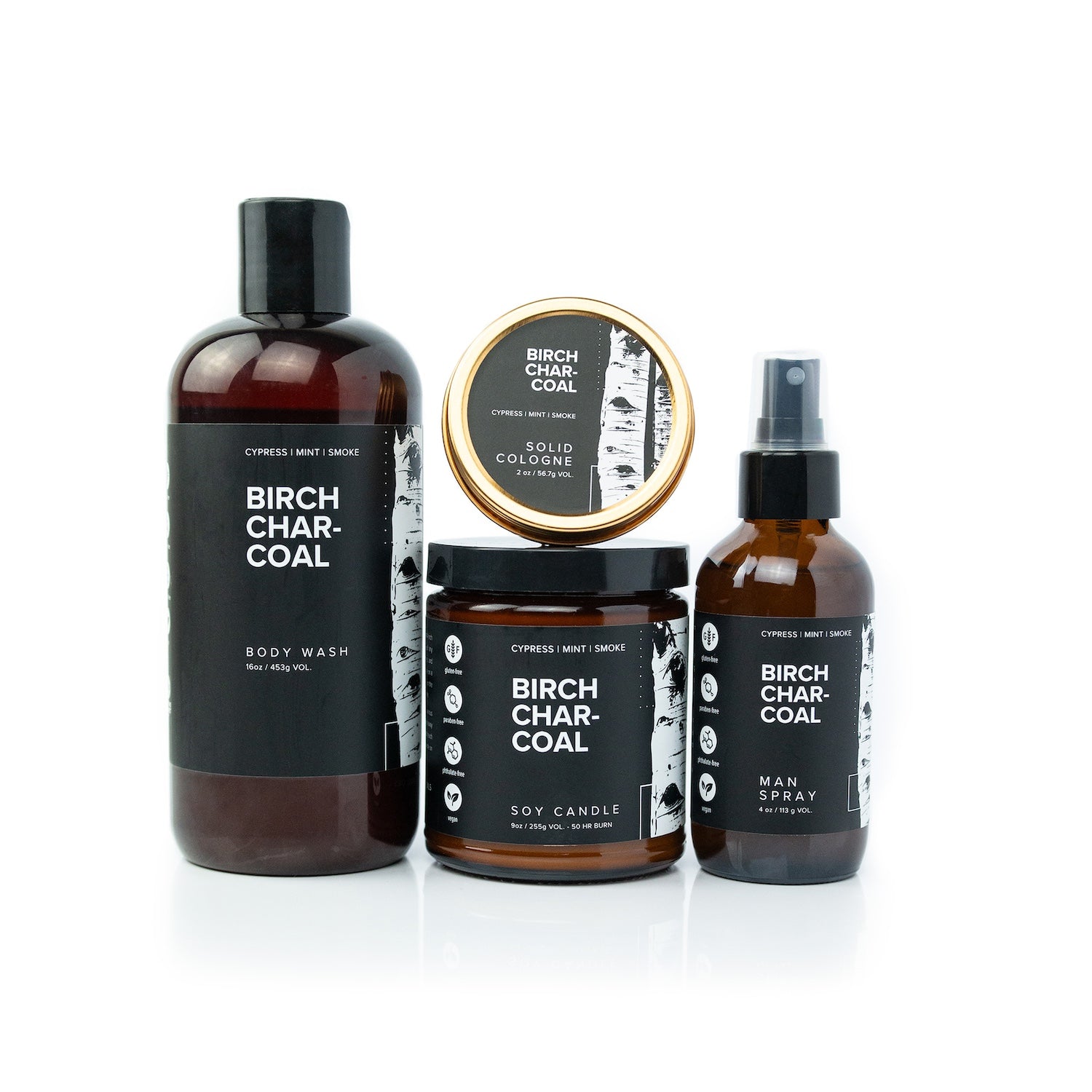 Birch Charcoal Bundle including 16oz Birch Charcoal Body Wash, Birch Charcoal Solid Cologne, 9oz Birch Charcoal Soy Candle, and 4oz Birch Charcoal Man Spray on white background. 