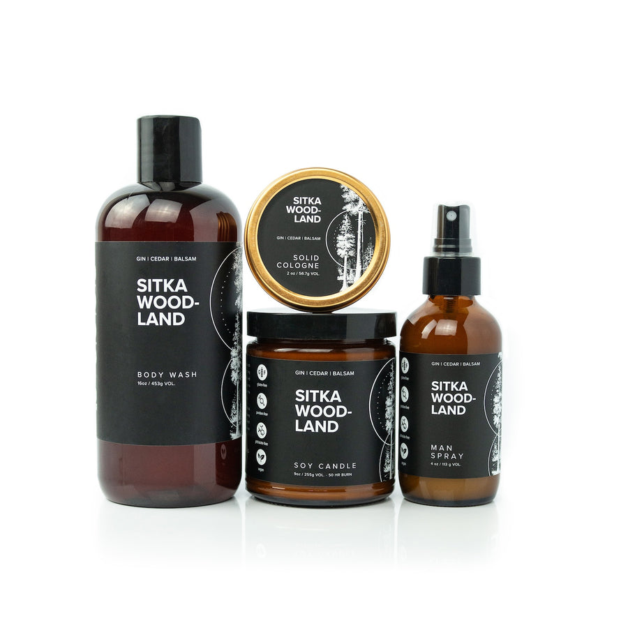 Sitka Woodland Bundle including 16oz Sitka Woodland Body Wash, Sitka Woodland Solid Cologne, 9oz Sitka Woodland Soy Candle, and 4oz Sitka Woodland Man Spray on white background. 