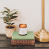 9oz Honey Horchata Soy Candle atop two books. 
