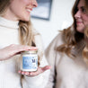 'Mom' 9oz Soy Candle being held by a woman's hands. 