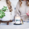 'Tough As A Mother' 9oz Soy Candle being lit by a long match. 