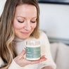 'La Dolce Vita' 9oz Soy Candle being smelled by a woman. 