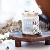 'Mom' 9oz Soy Candle on a decorative wooden stand. 