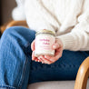 'Birthday Babe' 9oz Soy Candle being held by a woman's hands. 