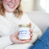 'Spill The Tea Sis' 9oz Soy Candle being held by a woman's hands. 