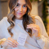 'Good Vibes Only' Air Freshener being held by a young woman. 