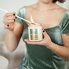 9oz Austy Lou Beach Blossom Soy Candle being lit by a long match. 