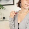 Austy Lou Citrus Crush Roll-On Perfume being applied to a woman's neck. 
