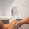 Lavender Mint Bar Soap being used in a white marble shower. 
