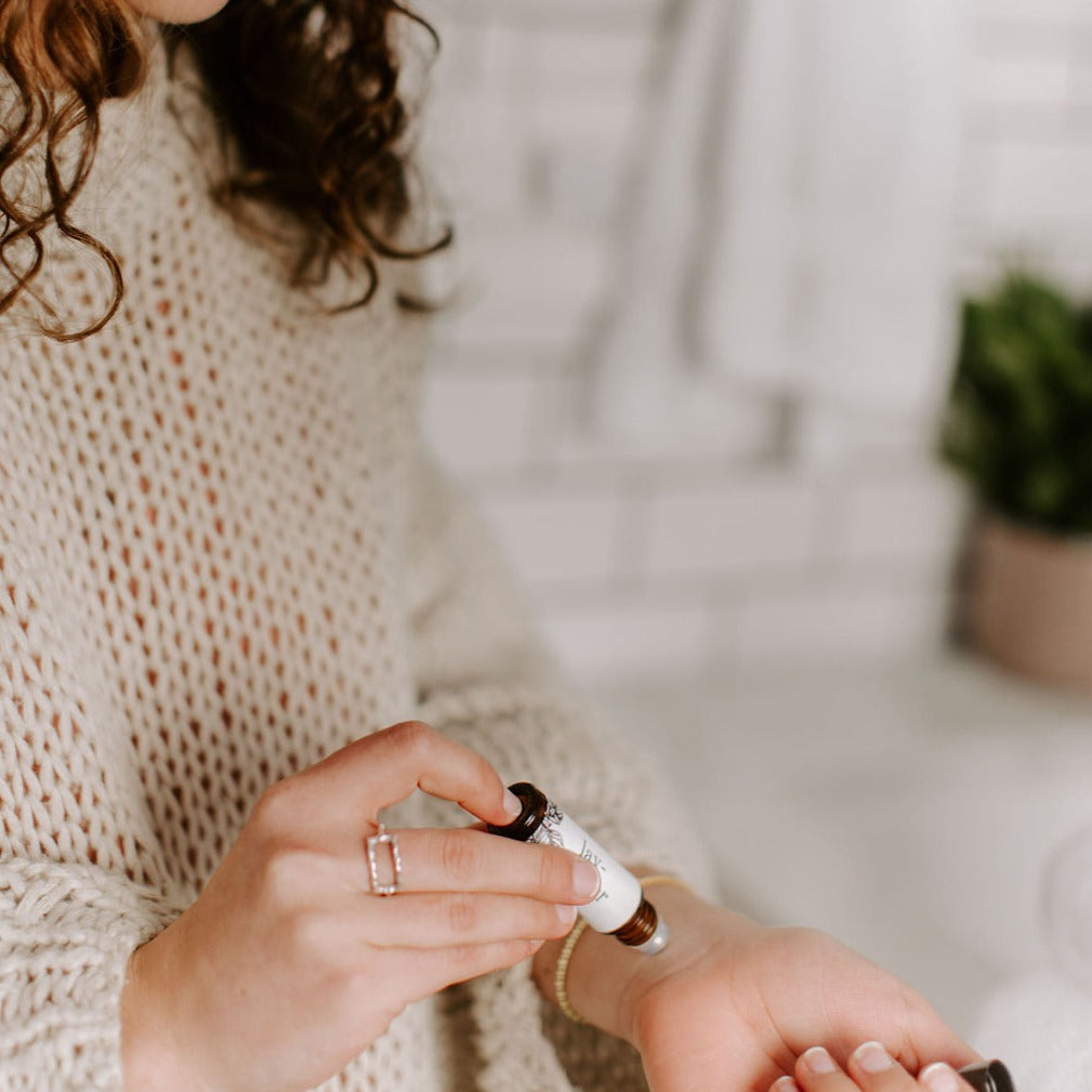Lavender Mint Roll-On Perfume being applied to a woman's wrist. 
