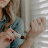 Lavender Mint Roll-On Perfume being applied to a woman's wrist. 