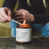 9oz Mount Bachelor Soy Candle being lit by a match. 