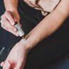 Mount Bachelor Roll-On Perfume being applied to a wrist. 