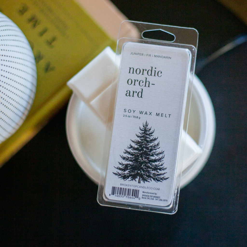 Nordic Orchard Wax Melt on top of a white wax melter. 