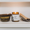 9oz Saguaro Cactus Soy Candle on a white shelf next to small decor. 