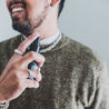 4oz Santal Noir Man Spray being sprayed by a man. 