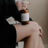 8oz Lavender Mint Body Lotion resting on a woman's leg. 