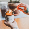 9oz Sea Salt Surf Soy Candle being lit by a match. 