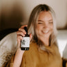 4oz Sea Salt Surf Linen Spray being sprayed by a woman. 