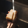 Sea Salt Surf Bar Soap being held under running water. 