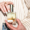 Sedona Perfume being held by two hands. 