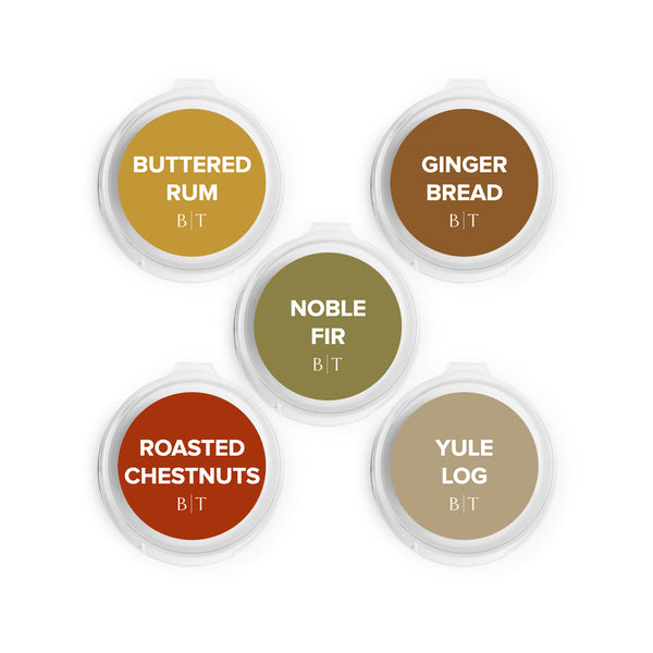 Buttered Rum, Gingerbread, Noble Fir, Roasted Chestnuts, and Yule Log Scent Samples on white background. 