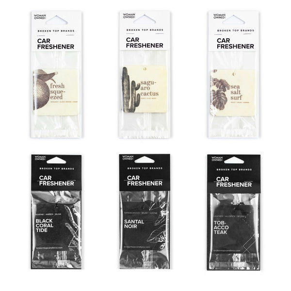 Fresh Squeezed, Saguaro Cactus, Sea Salt Surf, Black Coral Tide, Santal Noir, and Tobacco Teak Car Fresheners on white background. 