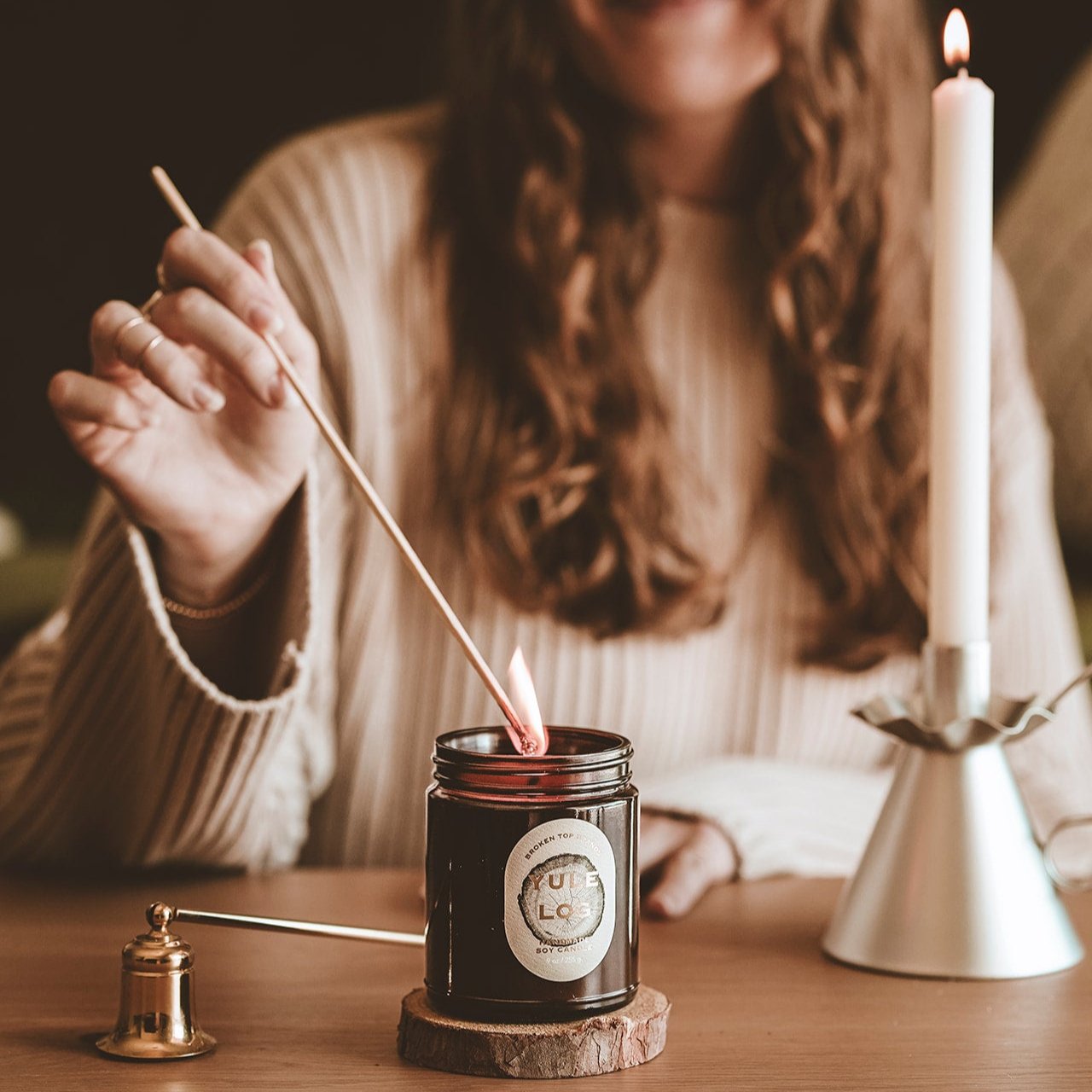 9oz Yule Log Soy Candle on being lit by a match. 