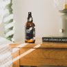 4oz Sitka Woodland Man Spray on a wooden side table. 