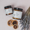9oz Lavender Mint Soy Candle next to dried lavender and citrus slices. 