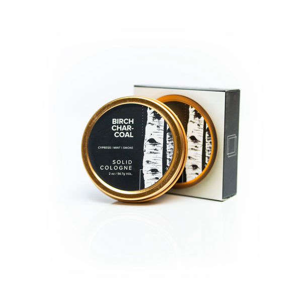 Birch Charcoal Solid Cologne on white background. 